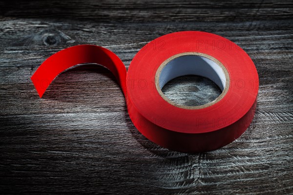 Red electrical tape on vintage wooden board