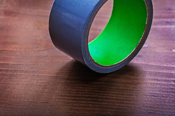 Adhesive tape on vintage brown wooden board construction concept
