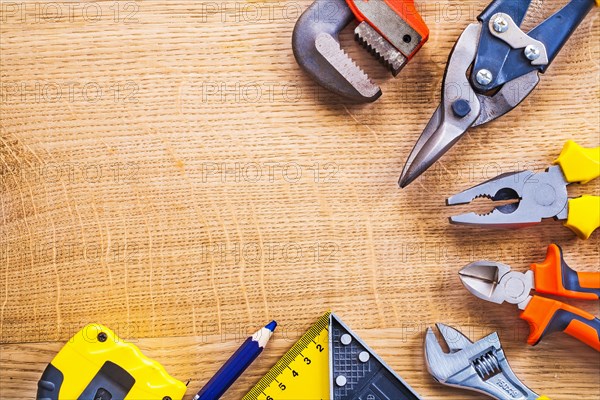 Organised copy room Monkey spanner Steel pliers Pliers Ruler Pencil Tapelie on wooden board