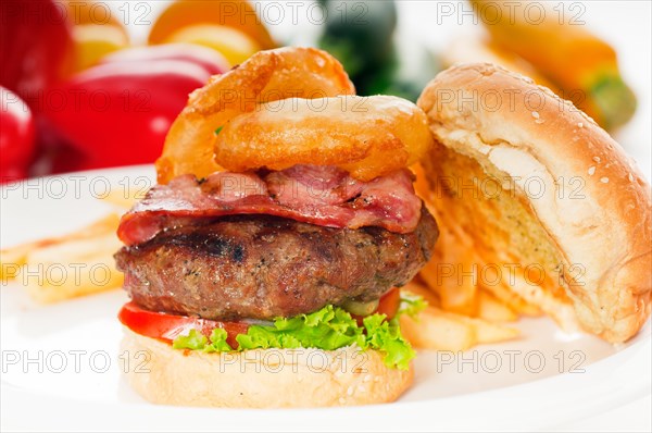 Classic american hamburger sandwich with onion rings and french fries