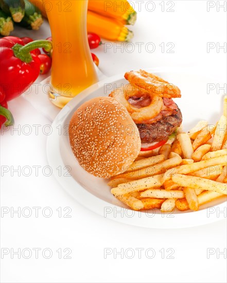 Classic american hamburger sandwich with onion rings and french fries