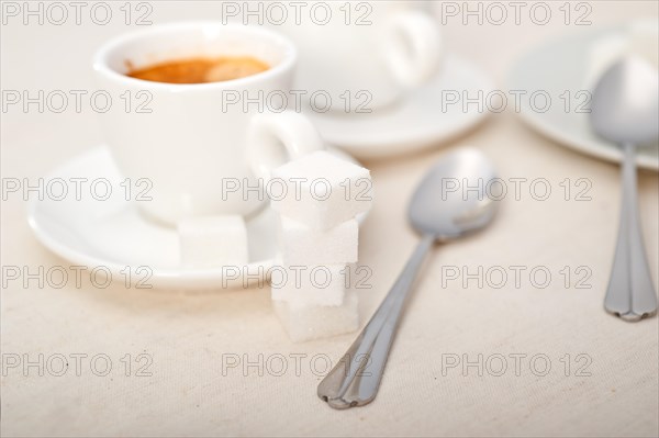 Italian espresso coffee fresh brewed macro closeup with sugar cubes