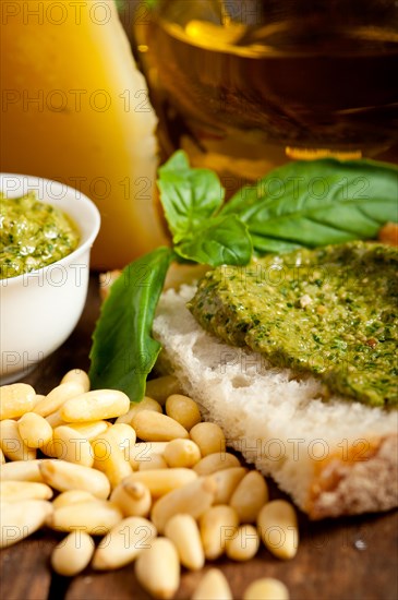 Italian basil pesto bruschetta ingredients over old wood macro