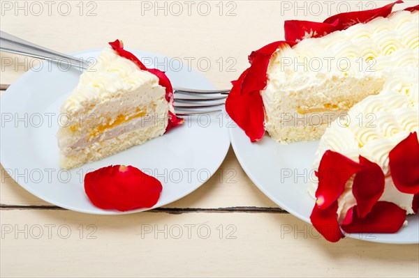 Whipped cream mango cake with red rose petals