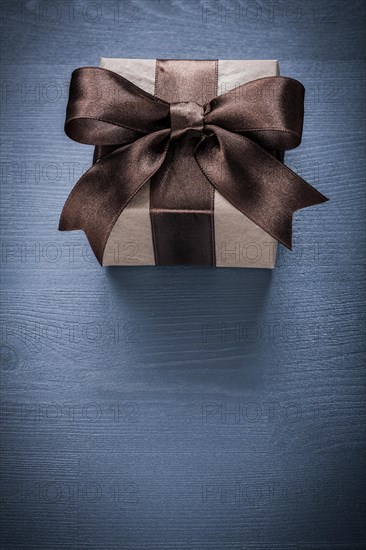 Wrapped giftbox on vintage wooden board holiday concept