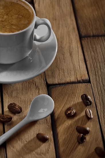 Coffee cup and spoon on wooden table