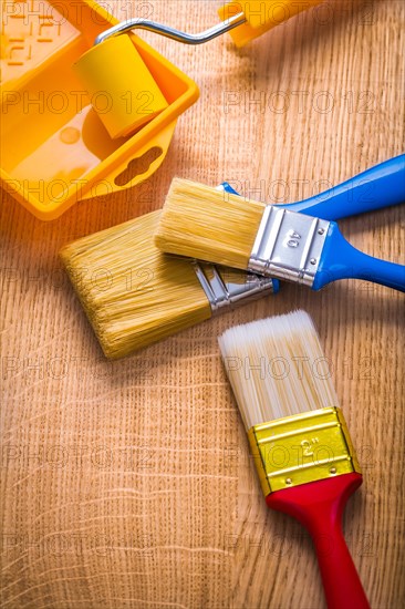 Compsition three brush roller and tray on wooden board