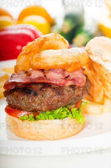 Classic american hamburger sandwich with onion rings and french fries