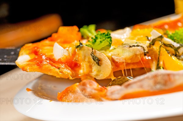 Fresh italian thin style vegetarian pizza with fresh mixed vegetables close up