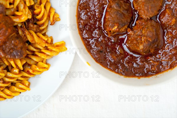 Fusilli pasta al dente with neapolitan style ragu meat sauce very different from bolognese style