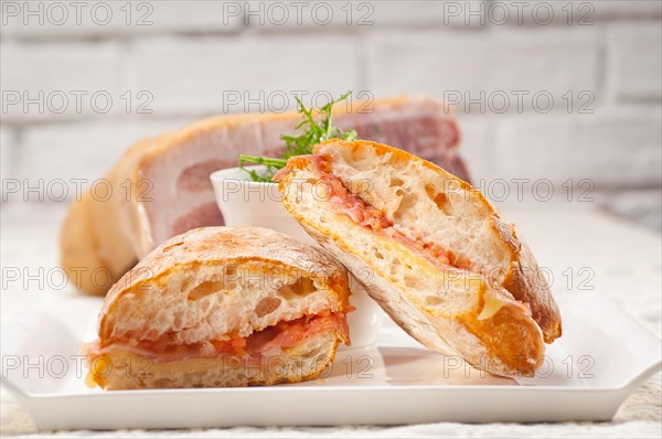 Italian ciabatta panini sandwich with parma ham and tomato