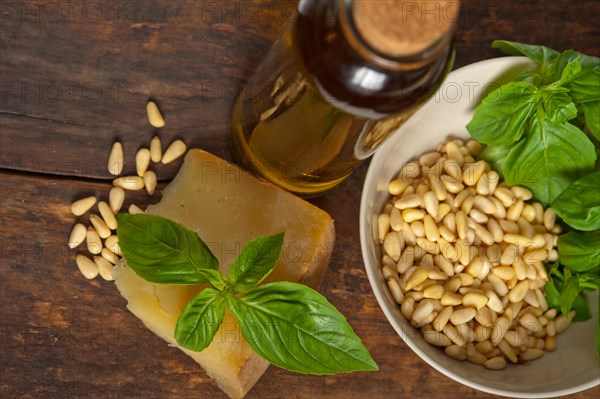 Italian basil pesto ingredients over old wood macro