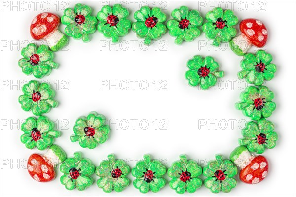 A frame of shamrocks with ladybirds and toadstools