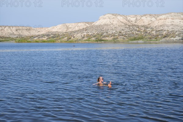 Woman bathing in the Tuz Kul salt lake