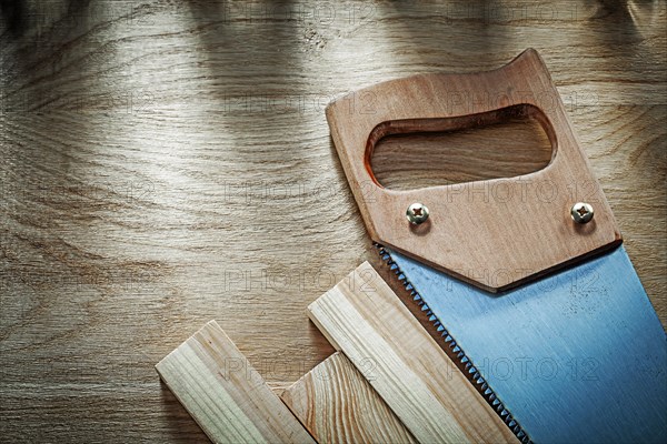 Handsaw wooden planks on wood board construction concept