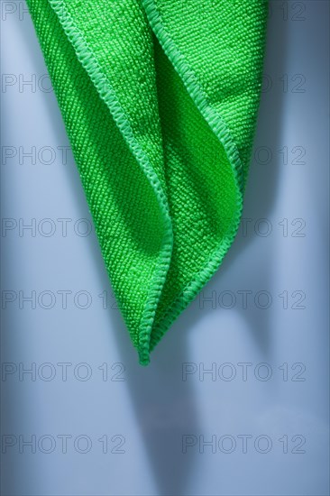 Green kitchen dishwashing cloth on white background
