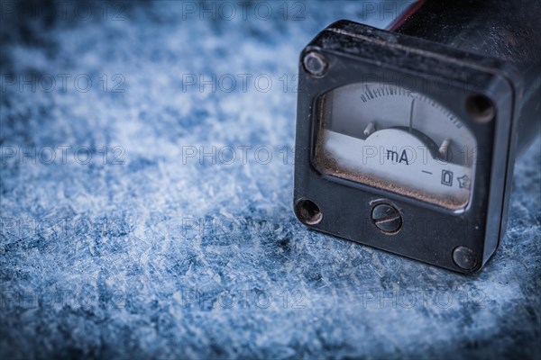 Amperemeter on scratched metallic background vintage electricity concept