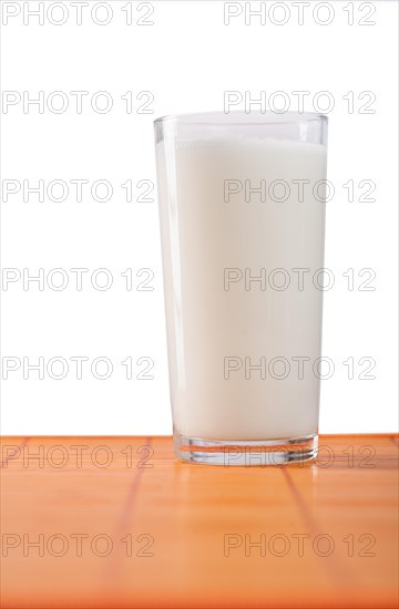 Glass of milk against a white background