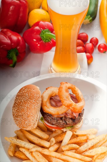 Classic american hamburger sandwich with onion rings and french fries