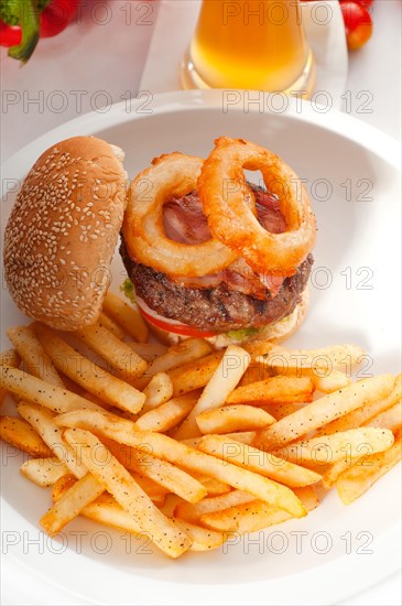 Classic american hamburger sandwich with onion rings and french fries