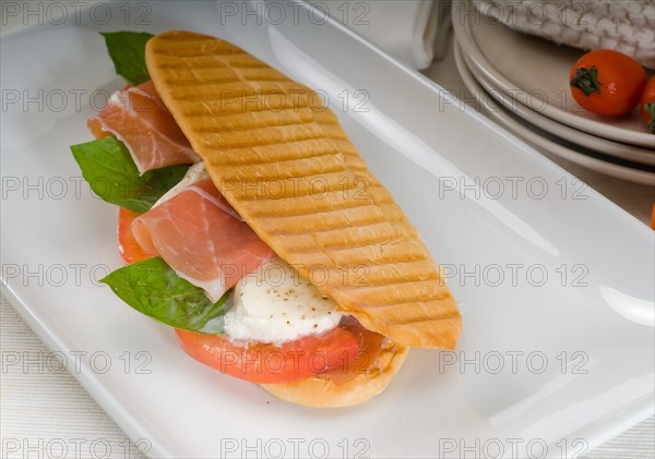 Panini sandwich with fresh caprese and parma ham