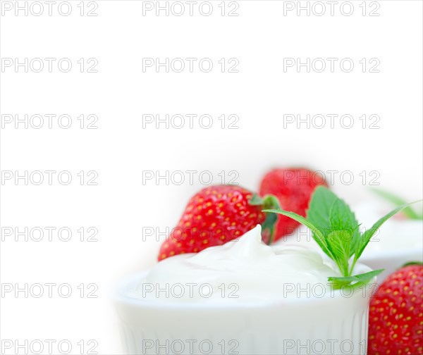 Organic Greek yogurt and strawberry over white rustic wood table