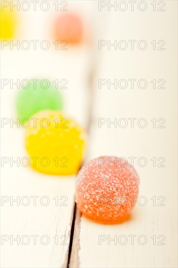 Sugar jelly fruit candy over white wood table