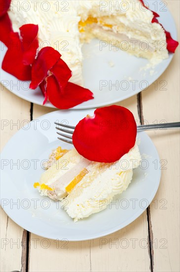 Whipped cream mango cake with red rose petals