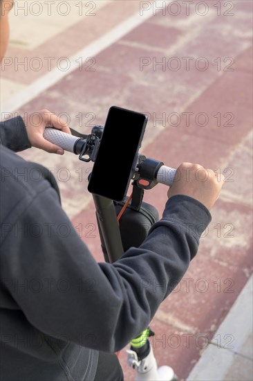 Young man riding an electric skateboard outdoors