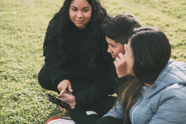 Hispanic family spending quality time together in a local park on a beautiful