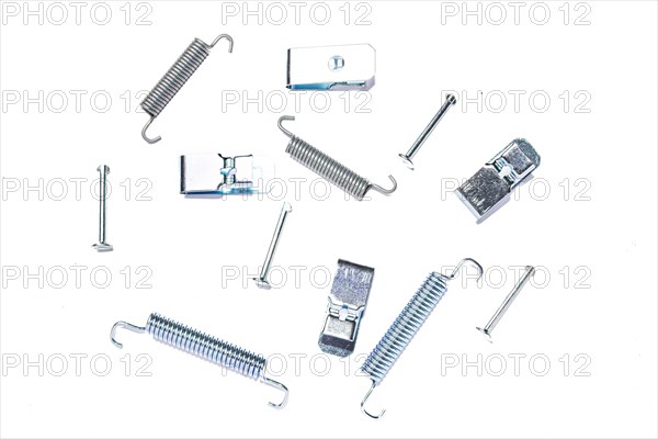 Repair kit of springs and clips for parking brake pads on white isolated background