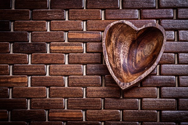 Heartshaped bowl on wooden matting food and drink concept