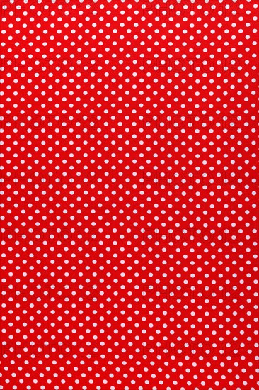 Red polka-dot cotton fabric vertical view