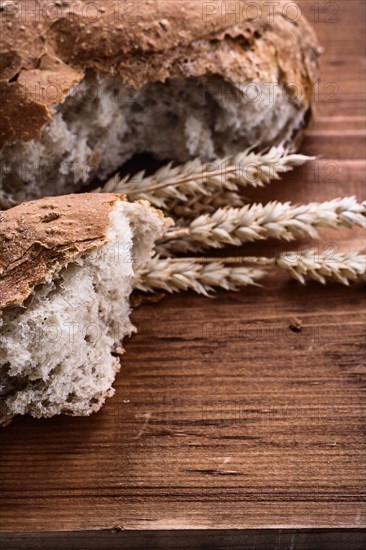 Sliced bread and eras of rye on vintage wooden board Food and drink concept