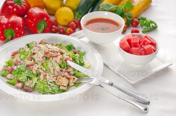 Fresh classic caesar salad served with gazpacho soup