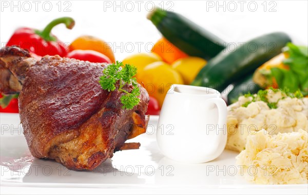 Original German BBQ pork knuckle served with mashed potatoes and sauerkraut