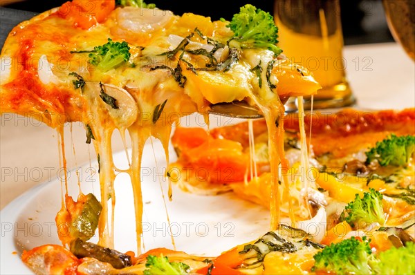 Fresh italian thin style vegetarian pizza with fresh mixed vegetables close up