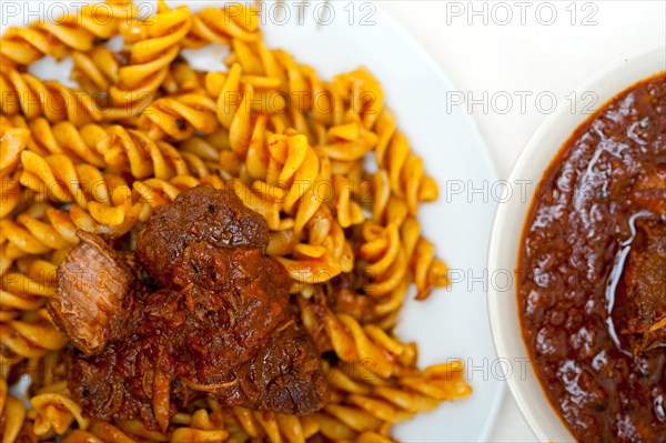 Fusilli pasta al dente with neapolitan style ragu meat sauce very different from bolognese style