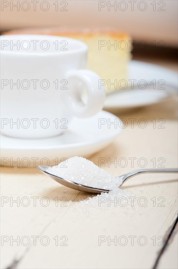 Italian espresso coffee and cheese cake over white wood table