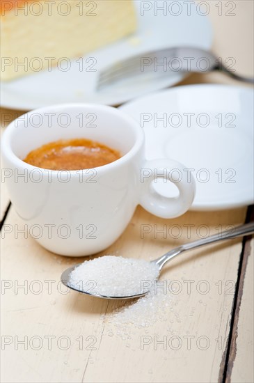 Italian espresso coffee and cheese cake over white wood table