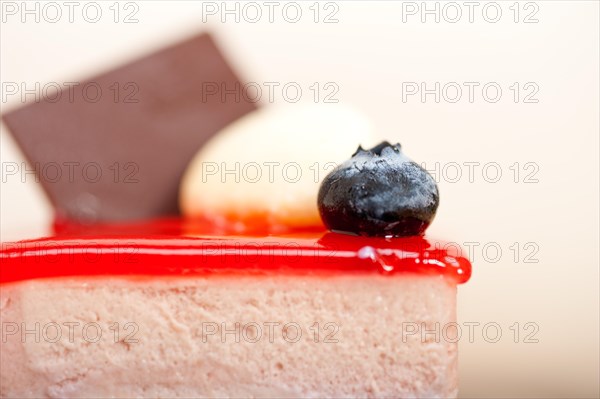 Fresh strawberry yogurt mousse with macaroon and blueberry on top