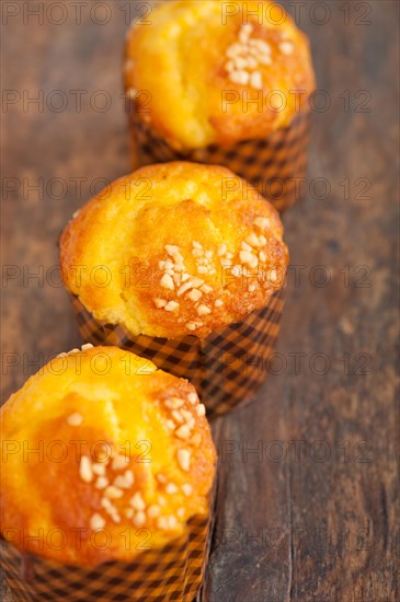 Fresh baked muffin on old wood table