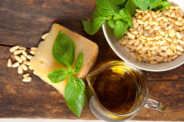 Italian basil pesto ingredients over old wood macro