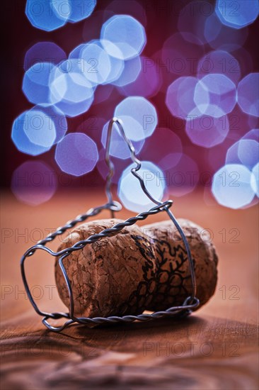 Champagne cork with wire on an old wooden table