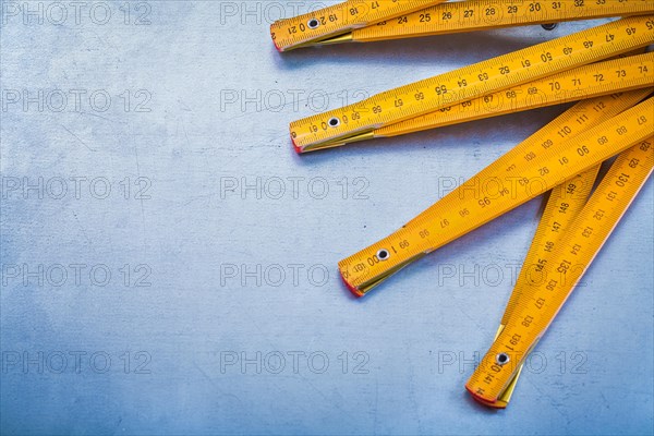 Copy space image of wooden metre on metallic background construction concept
