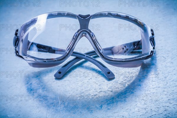 Plastic safety spectacles on a metallic background Design concept