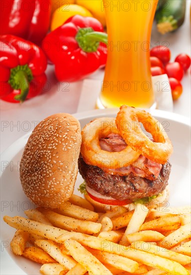 Classic american hamburger sandwich with onion rings and french fries