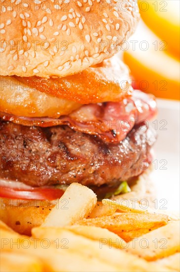 Classic american hamburger sandwich with onion rings and french fries