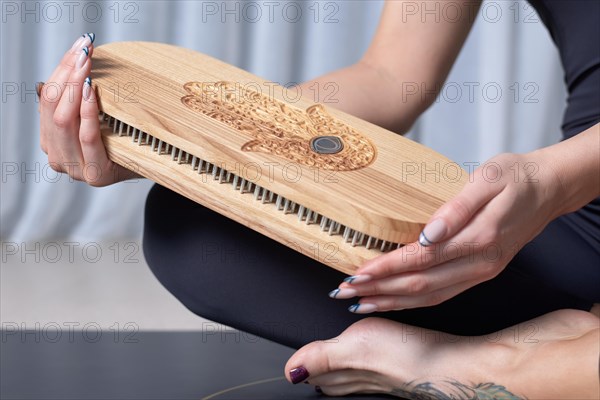 Image of a Sadhu board in female hands. Yoga concept. Spiritual practices. Mixed media