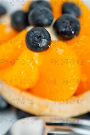 Fresh blueberry and tangerine orange cream cupcake homemade closeup macro